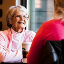 older woman and adult daughter talking about estate plan