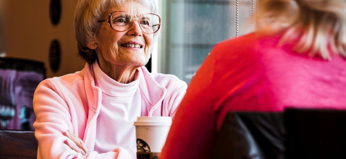 older woman and adult daughter talking about estate plan