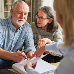 couple signing durable power of attorney document with attorney