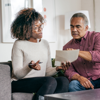 father and adult daughter looking at estate planning documents